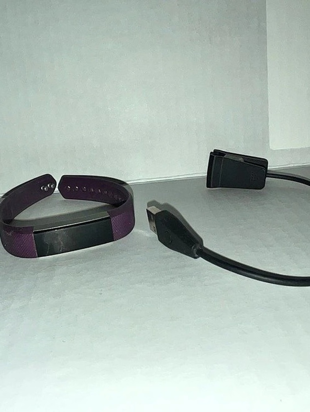 Purple FitBit Fitness Tracker with Charging Cable